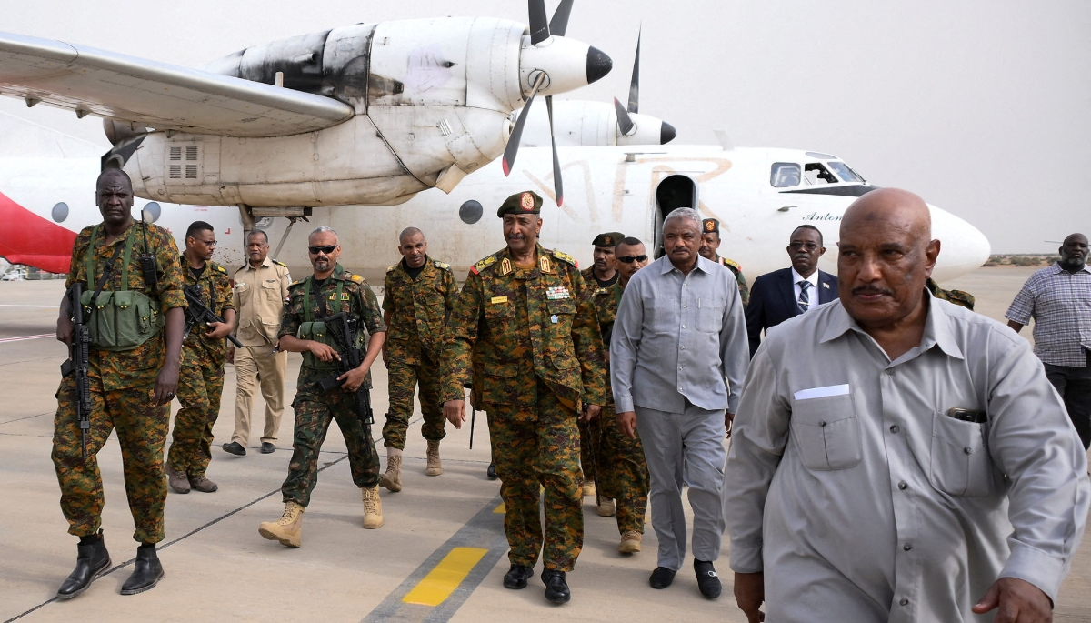 Sudan's General Abdel Fattah al-Burhan (centre) arrives at the military airport at Port Sudan, 27 August 2023.