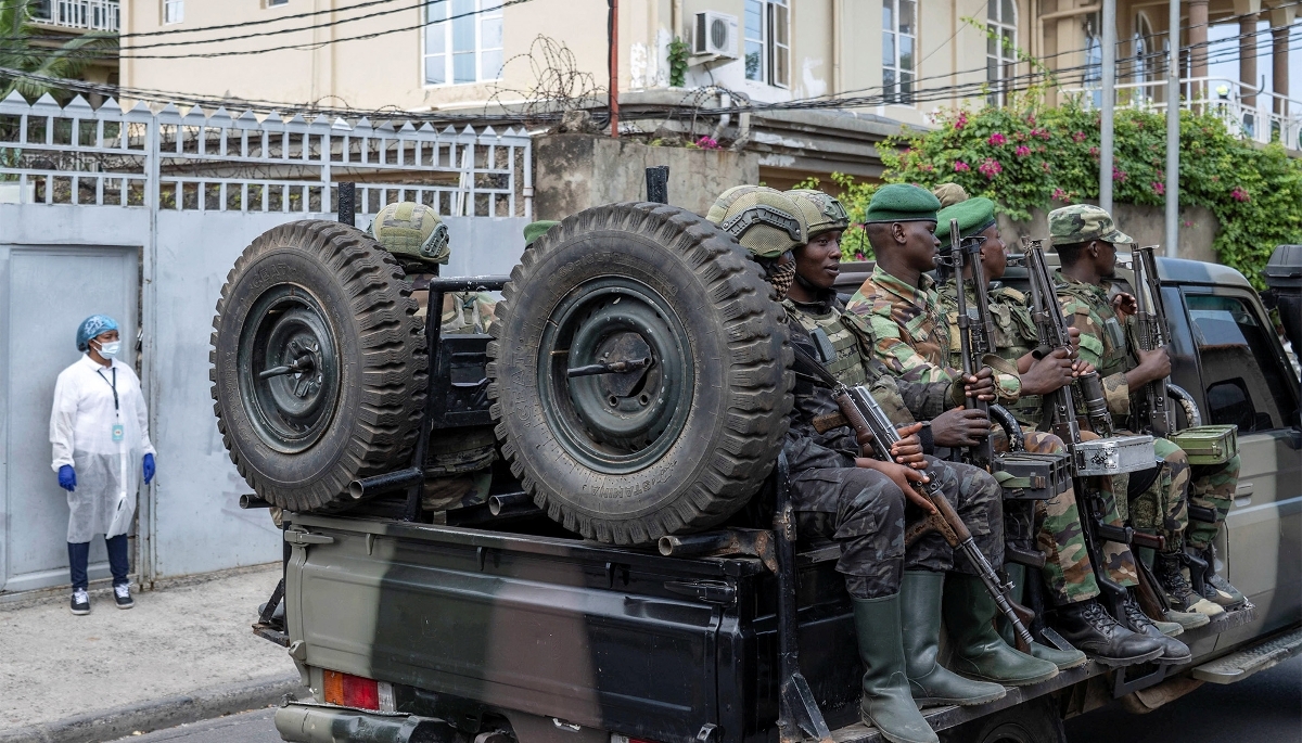 Soldiers of the M23 rebel group ride on a pickup truck as they leave a laboratory in Goma, North Kivu province, in May 2026. 