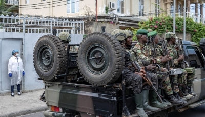 Soldiers of the M23 rebel group ride on a pickup truck as they leave a laboratory in Goma, North Kivu province, in May 2026. 