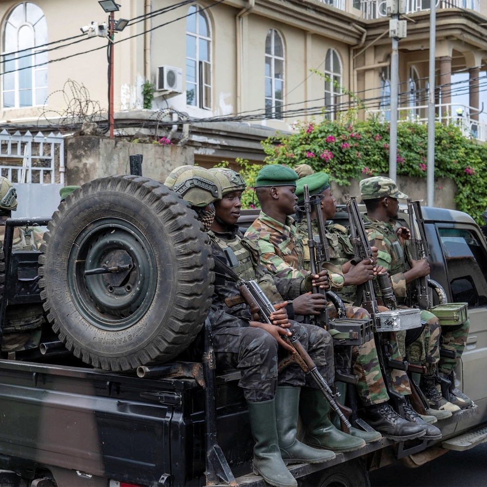 Soldiers of the M23 rebel group ride on a pickup truck as they leave a laboratory in Goma, North Kivu province, in May 2026.