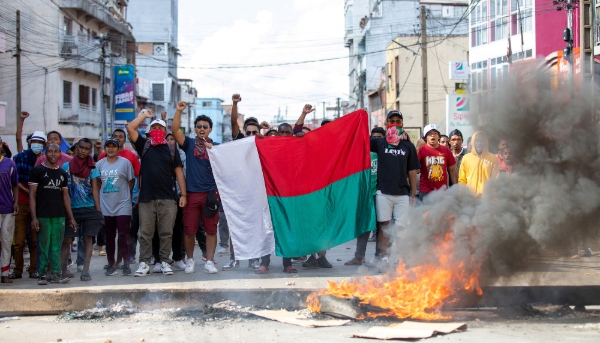 Opposition demonstrators hold a flag during a demonstration in Andravoahangy, Antananarivo, on 11 November 2023.