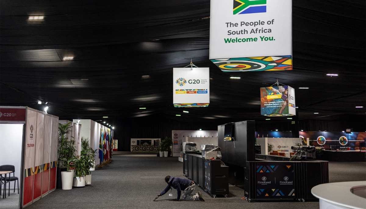 A worker repositions a carpet at the Nasrec Expo Centre ahead of the G20 leaders' summit in Johannesburg on 18 November 2025.