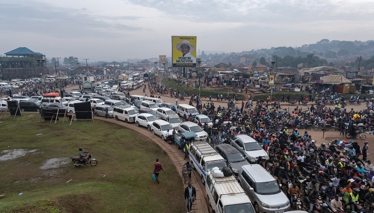 A campaign billboard for Yoweri Museveni erected over traffic in Kampala, 24 December 2025.
