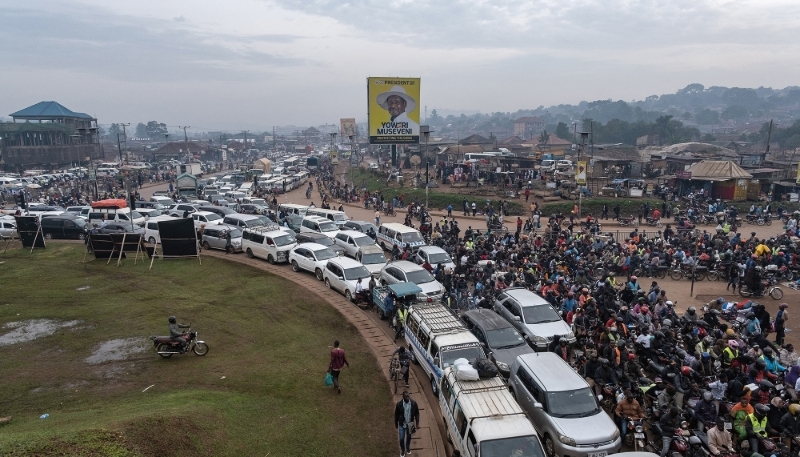 A campaign billboard for Yoweri Museveni erected over traffic in Kampala, 24 December 2025.