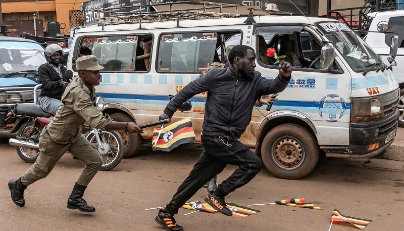Police officers attempt to arrest a protester taking part in a demonstration in support of opposition figures in Kampala, on 2 February 2026.