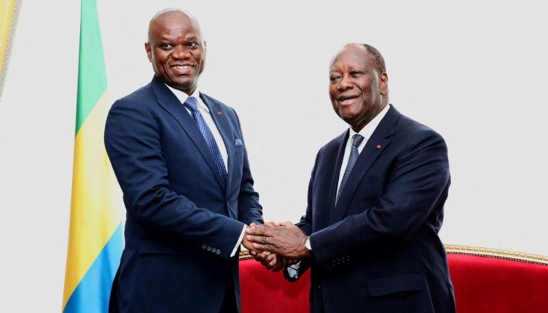 Gabon's then transitional President Brice Clotaire Oligui Nguema (left) with President Alassane Ouattara at Abidjan's presidential palace, Ivory Coast, 12 April 2024.