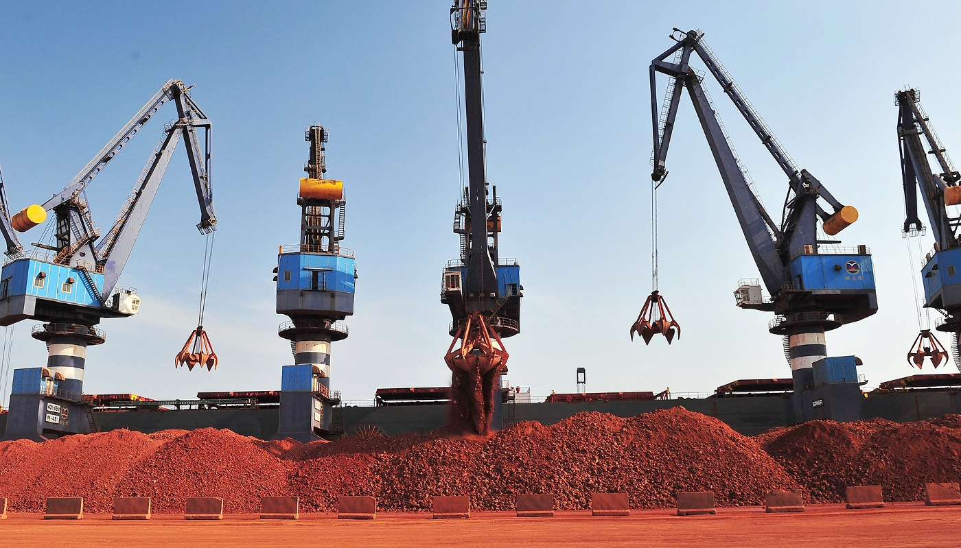 A ship unloads Guinean bauxite in the port of Yantai, China in 2017.