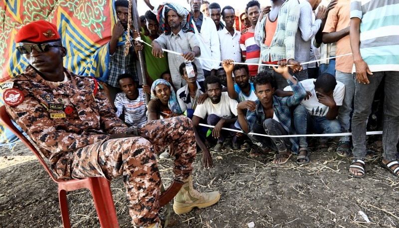A Sudanese military officer keeps guard Ethiopians who fled war in Tigray region at the Fashaga camp, Sudan, on 20 November 2020.