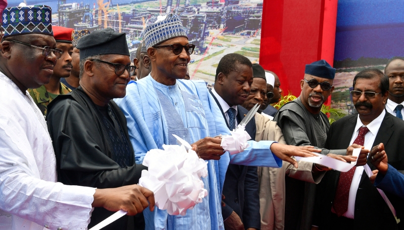 Former Nigerian president Muhammadu Buhari (C) cuts the ribbon to inaugurate the Dangote Petroleum Refinery flanked by (from R to L) Senate President Ahmad Lawan, President/CEO Dangote Industries, Aliko Dangote, Togolese President Faure Gnassingbe, All Progressives Congress (APC) chairman Abdullahi Adamu, Governor Dapo Abiodun, and Group executive director of Dangote Industries, Devakumar Edwin in Lagos, on 22 May 2023.