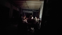 Tunisians play cards by the light of their phones at a café during a nighttime power outage in Tunis's Ariana neighbourhood, on 14 July 2026. 
