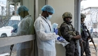 Members of the AFC-M23 and an employee outside the Goma branch of the National Institute of Biomedical Research in DRC, on 19 May 2026.