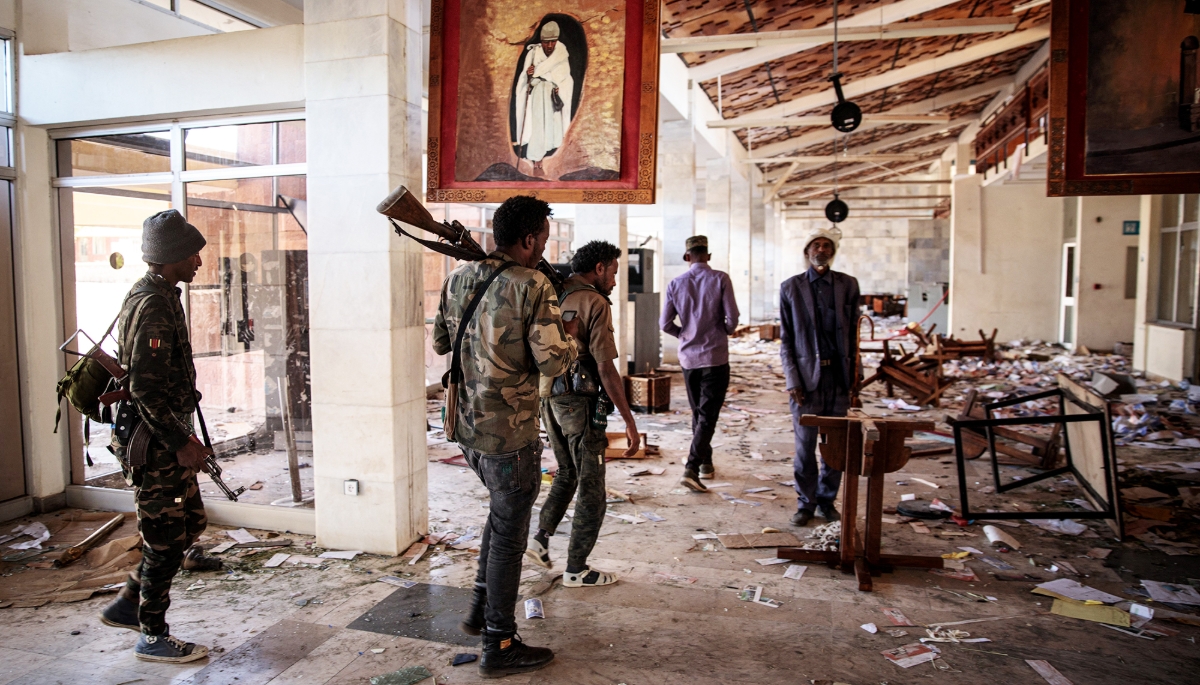 Amhara Fano militia fighters walk in the ransacked terminal at the Lalibela airport in Lalibela, 7 December 2021.