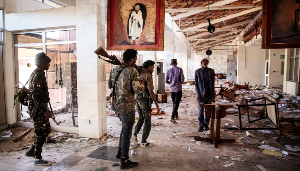 Amhara Fano militia fighters walk in the ransacked terminal at the Lalibela airport in Lalibela, 7 December 2021.