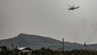 A helicopter belonging to the DRC's armed forces flies over Sake, in North Kivu, DRC, in January 2025.