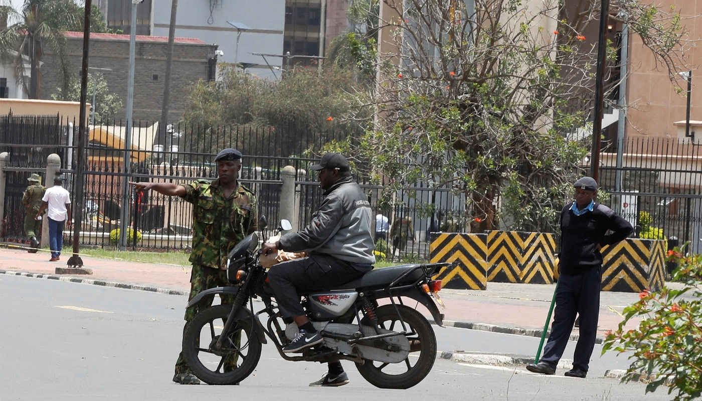 Kenyan police officers secure pedestrians from accessing Parliament road, ahead of the lawmakers' move to launch impeachment proceedings against Deputy President Rigathi Gachagua, in Nairobi, on 1 October 2024.