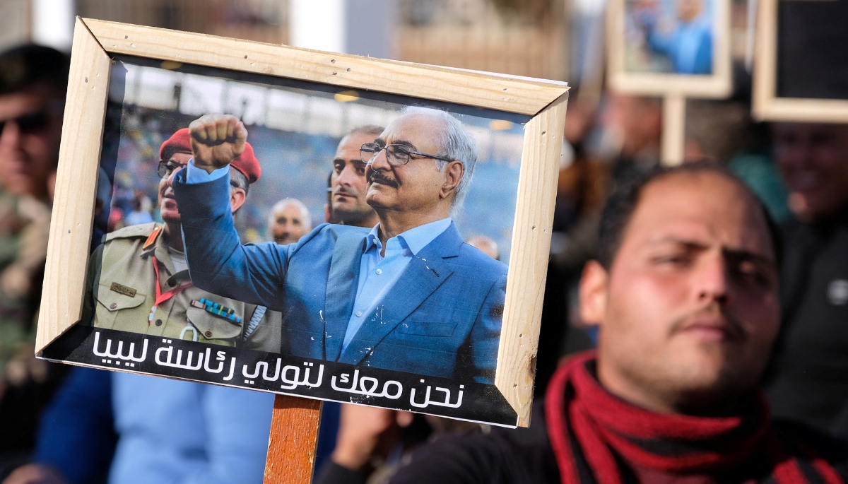 A man holds a picture of Khalifa Haftar in Benghazi, Libya, 24 December 2022.