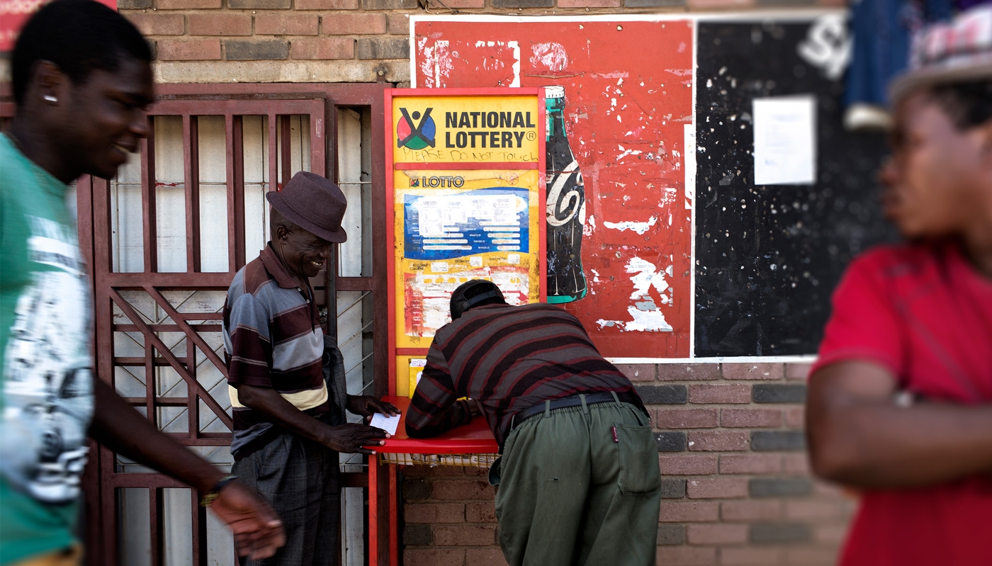 People playing the National Lottery at a supermarket in the South African town of Marikana in April 2014.