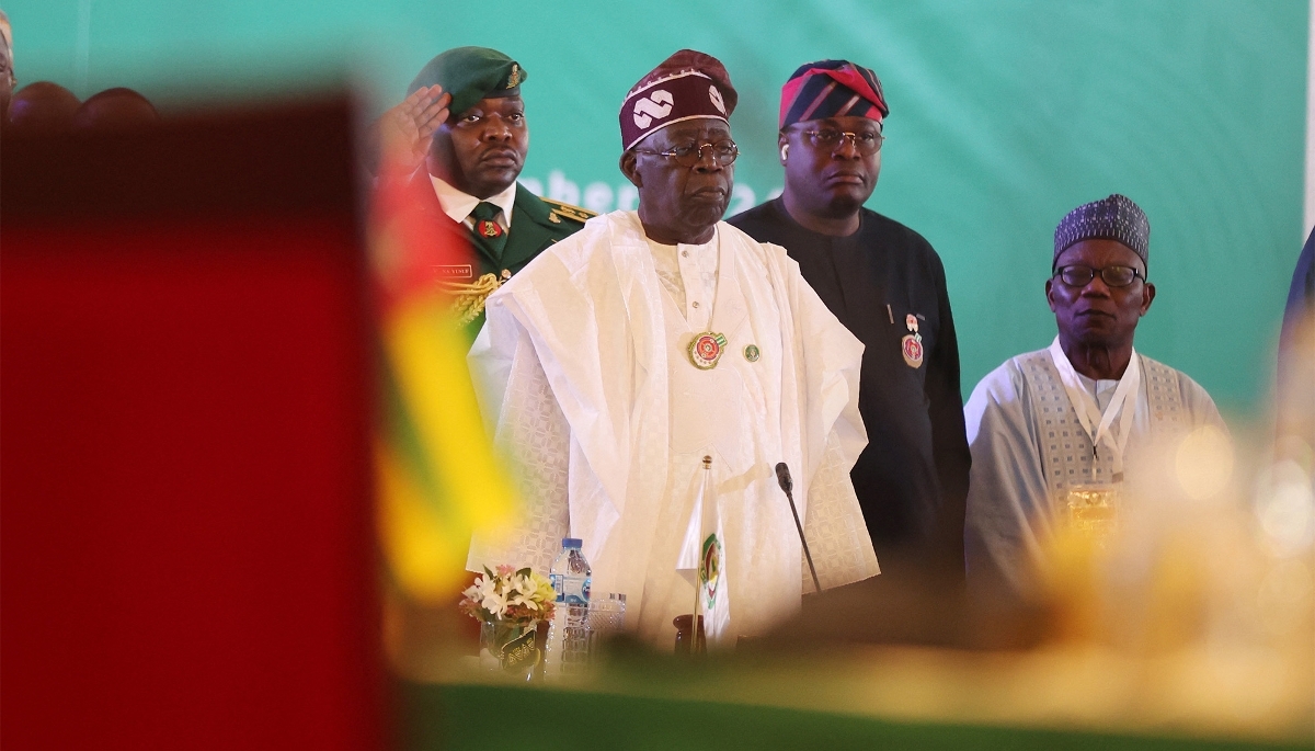Nigerian President Bola Ahmed Tinubu (centre, in white) in Abuja in December 2024. 
