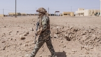 An FLA fighter inspects the area following a FAMa air strike in Kidal, Mali, on 14 May 2026.