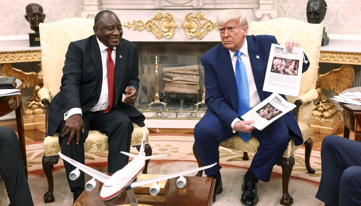 Donald Trump displays news articles on violence in South Africa during Cyril Ramaphosa's visit to Washington DC on 21 May 2025.