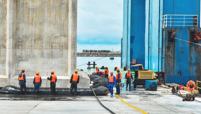 Technicians working to install the first caisson in phase II of the construction of the Kribi Deep Seaport, Cameroon, in October 2022.