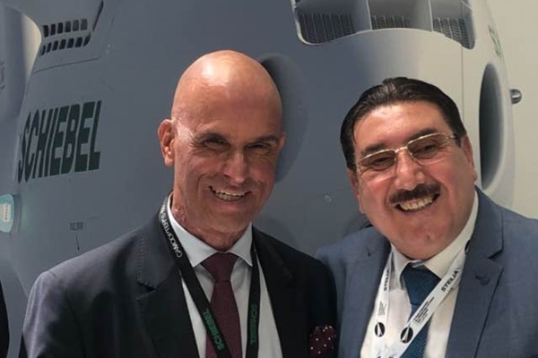 Jalel Bouabcha (r) in front of a Schiebel Camcopter-100.