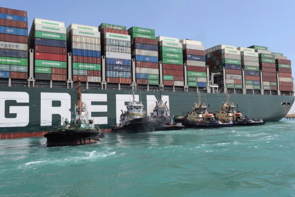 Rescue vessels work at the site of the stuck container ship Ever Given on the Suez Canal, 28 March 2021.