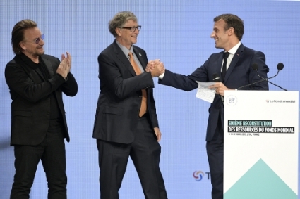French president Emmanuel Macron, with Bono and Bill Gates, announces the amount raised at the 6th Global Fund to Fight AIDS, Tuberculosis and Malaria replenishment conference in Lyon on 10 October 2019.