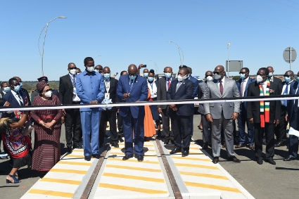 Botswanan President Mokgweetsi Masisi cuts the ribbon to mark the official opening of the Kazungula Bridge connecting Botswana and Zambia on May 10, 2021.