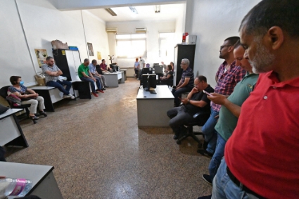 Journalists on strike, employed by the Algerian El-Watan newspaper, take part in a meeting at the headquarteres of the daily press publication, in Algiers, on 27 July 2022.
