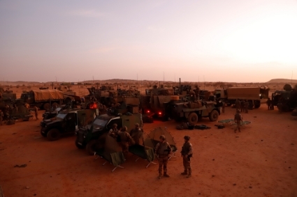 French soldiers from Operation Barkhane set up a temporary advanced operating base as they leave Gossi, Mali, on 18 April 2022.