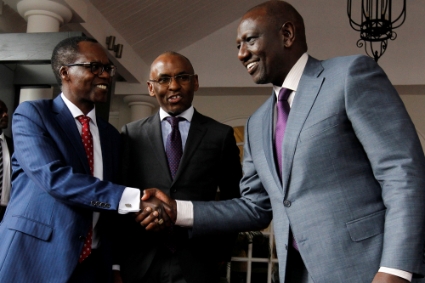 William Ruto greets NCBA Bank CEO John Gachora as Safaricom CEO Peter Ndegwa looks on after a press conference in Nairobi on 28 September 2022.