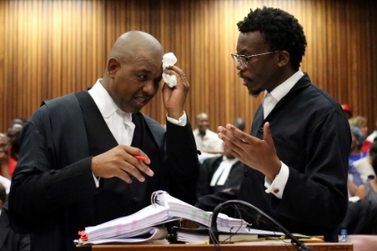 Advocate Dali Mpofu (L) reacts as he chats to Advocate Tembeka Ngcukaitobi during court hearing arguments on a report into allegations of political interference by wealthy friends of President Jacob Zuma, at the North Gauteng High Court, in Pretoria, South Africa, 2 November 2016.