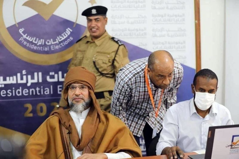 Saif al-Islam Gaddafi (left), son of former Libyan leader Muammar Gaddafi, registering to run in the upcoming presidential elections in the city of Sebha, south of Tripoli, Libya, 14 November 2021.