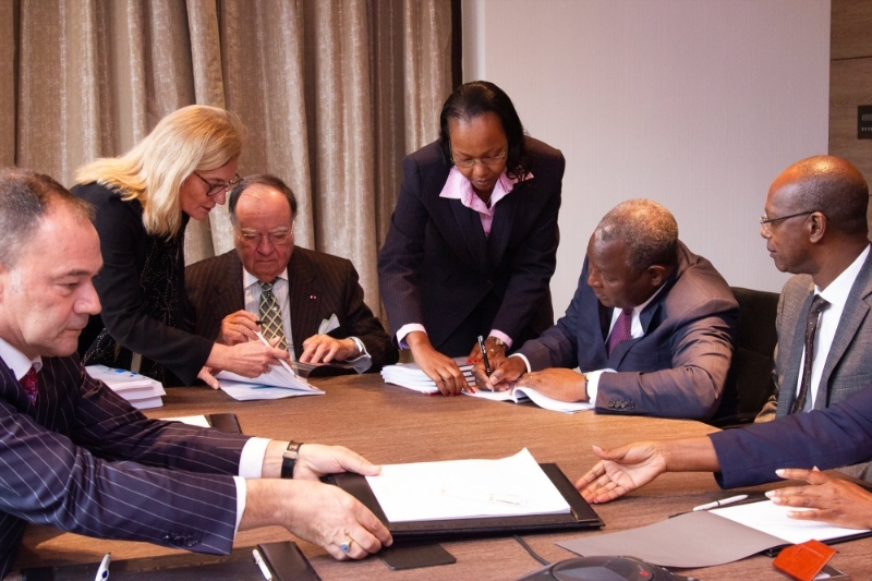 Equity Group MD & CEO Dr. James Mwangi signs the purchase agreement with BCDC Majority Shareholder Mr. George Forrest.