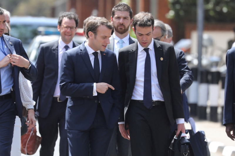 French president Emmanuel Macron and his Africa advisor Franck Paris walk in a street, on March 14, 2019, in Nairobi.
