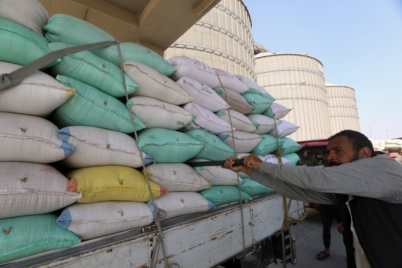 Workers collect wheat at the Banha grain silos, in Qalyubia Governorate, Egypt, 25 May 2022.