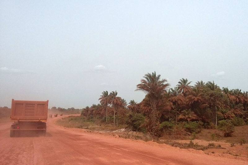 The passage of trucks transporting bauxite throws up toxic red dust, pictured here in the vicinity of Boké.