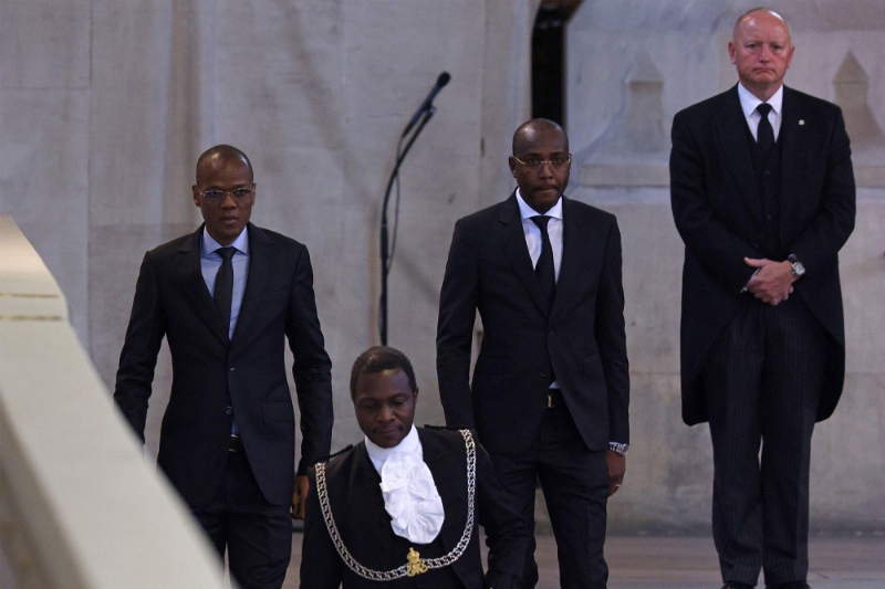 Chad's Minister of Petroleum and Energy, Djerassem Le Bemadjiel (left) pays his respect as he passes the coffin of Queen Elizabeth II, at the Palace of Westminster, London, on 18 September 2022.