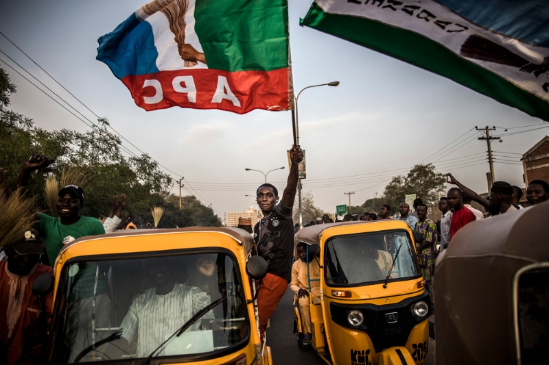 An All Progressives Congress Party (APC) supporter waves a party flag in Kano, on 25 February 2019.