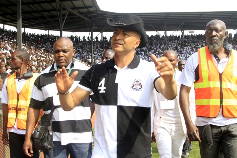 Moise Katumbi, wearing a TP Mazembe jersey, salutes supporters in the club stadium in Lubumbashi.