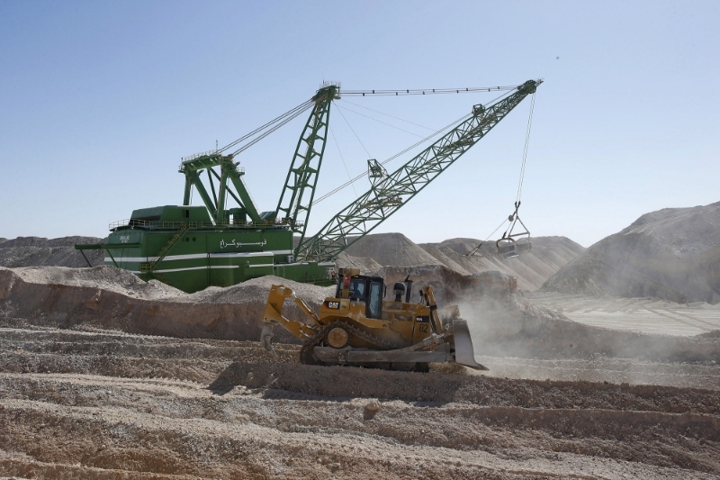 A dragline carries untreated phosphate after being dropped off on a mountain at a phosphate mine at the Boucraa factory of the National Moroccan phosphate company (OCP) situated in the southern provinces.