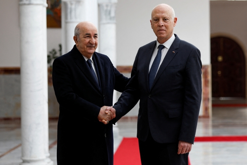 Tunisian President Kaïs Saïed (right) welcomes his Algerian counterpart Abdelmadjid Tebboune on his arrival in Tunis on 15 December 2021.