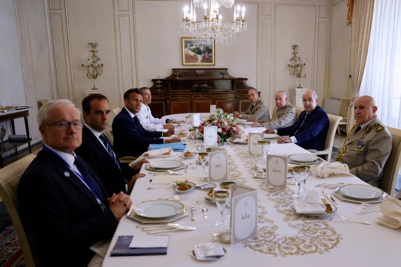 Director of the DGSE Bernard Emie, French Armies Minister Sebastien Lecornu, French President Emmanuel Macron and French Chief of the Defence Staff General Thierry Burkhard, attend a lunch with Algerian President Abdelmadjid Tebboune (2nd R) and Algerian generals at the presidential residence in Zeralda on 26 August 2022, during an official visit to Algeria.