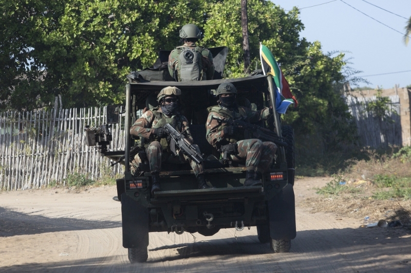 A military convoy of South African National Defence Force (SANDF) rides along a dirt road near Pemba on 5 August 2021.