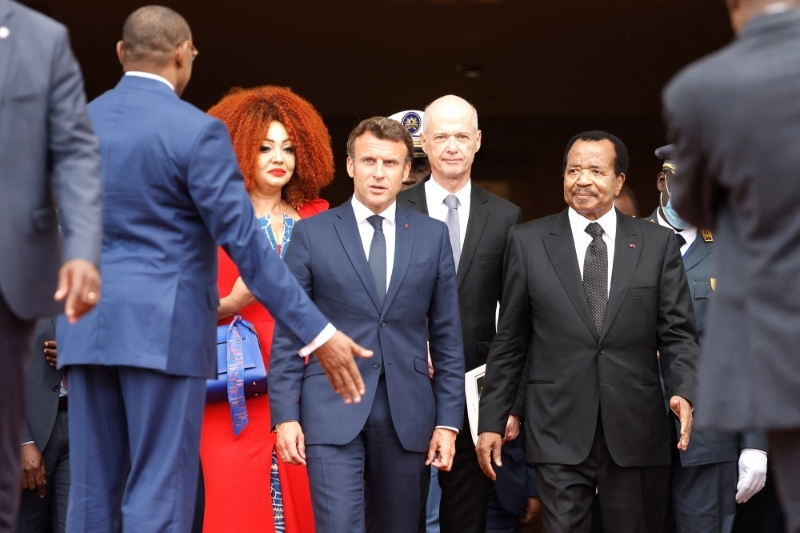 France's Macron (L), Cameroon's Biya (R) with French Ambassador to Cameroon Christophe Guilhou in between, Yaoundé, 26 July 2022.